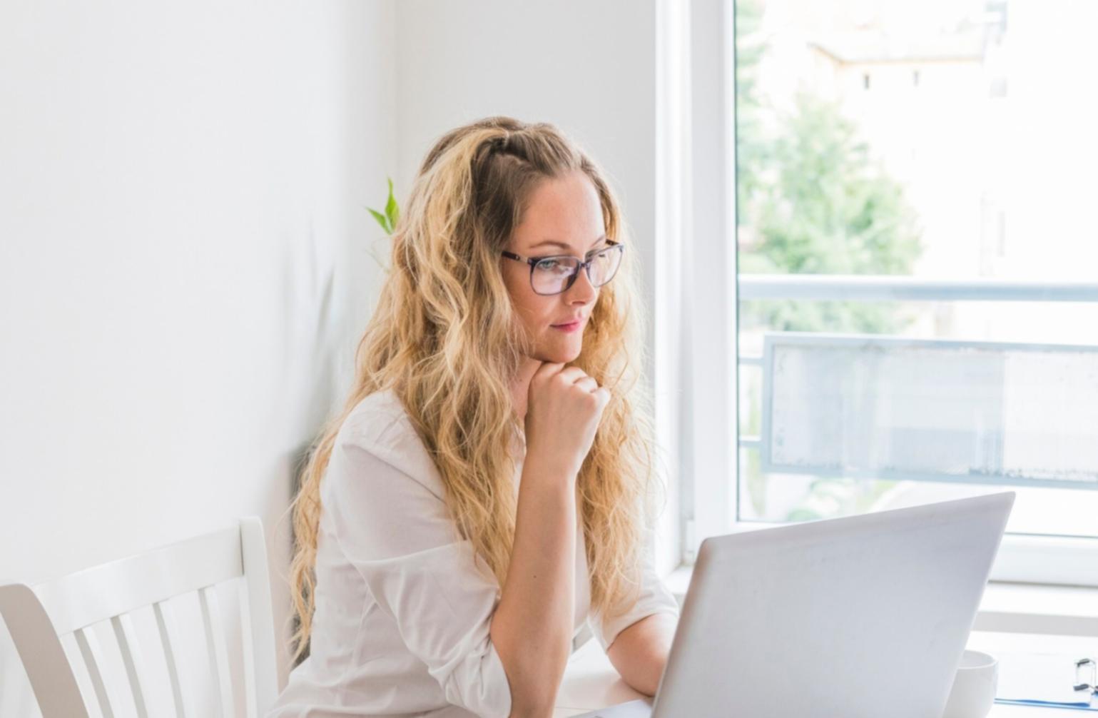 Small business owner reviewing financial documents in modern office setting